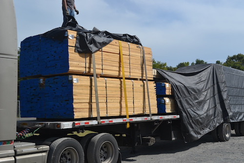 Lumber with ends painted with CosPaint on a truck